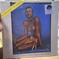Copertina Alberto Baldan Bembo The Soul of Ali Ben Djamballa Joker SM 3649 - donna africana in posa su sfondo blu con gioielli e gonna dorata, scritta gialla The soul of Ali Ben Djamballa in diagonale in alto a sinistra, tracklist in basso, sticker Record Store Day 2024 Limited Clear Blue Vinyl Edition in alto a destra, etichetta Joker Stereo in alto a sinistra