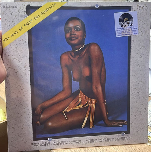 Copertina Alberto Baldan Bembo The Soul of Ali Ben Djamballa Joker SM 3649 - donna africana in posa su sfondo blu con gioielli e gonna dorata, scritta gialla The soul of Ali Ben Djamballa in diagonale in alto a sinistra, tracklist in basso, sticker Record Store Day 2024 Limited Clear Blue Vinyl Edition in alto a destra, etichetta Joker Stereo in alto a sinistra
