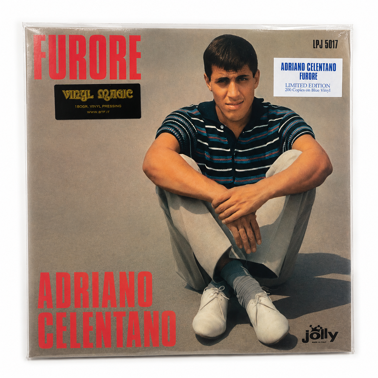 Copertina Adriano Celentano Furore Jolly Records LPJ 5017 - Celentano seduto in maglia a righe e scarpe bianche su sfondo beige, scritta rossa FURORE in alto a sinistra e ADRIANO CELENTANO in basso, sticker Vinyl Magic 180g btf.it in alto a sinistra, sticker Limited Edition 200 Copies on Blue Vinyl in alto a destra, logo Jolly in basso a destra